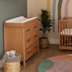 a baby crib and dresser in a child's room