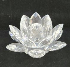 a clear crystal flower on a black surface