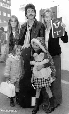 an old black and white photo of people with children holding up signs in front of them