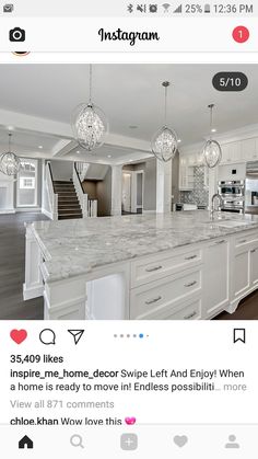 an instagramted photo of a kitchen with white cabinets and marble countertops