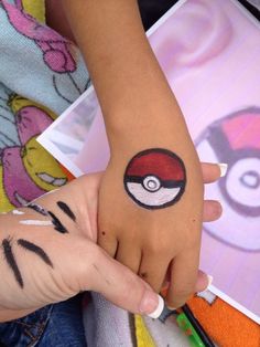 Pokeball Face Paint, Soccer Ball Face Paint, Easy Small Face Paint Ideas, Pokemon Face Paint Easy, Cheek Art Face Paint Simple, Pokemon Face Painting, Easy Face Painting Ideas For Kids Simple Cheek Art, Easy Face Painting Designs Simple, Pokemon Face Paint