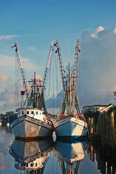 two fishing boats are docked in the water