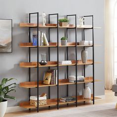 a living room with a large book shelf filled with books and vases on top of it