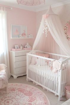 a baby's room with pink and white decor