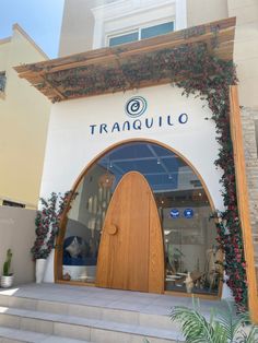 the entrance to tranquilo is decorated with greenery