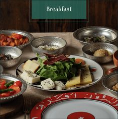 a table topped with plates and bowls filled with food