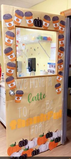 a classroom door decorated with pumpkins and cupcakes for the school's fall decorations