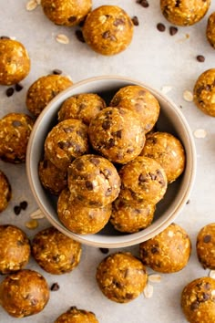 pumpkin energy bites in a bowl surrounded by raisins