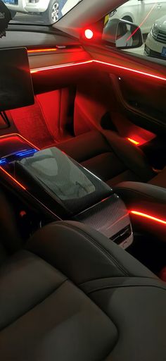 the interior of a car with red and blue lights