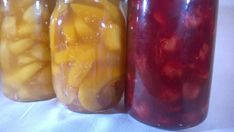 three jars filled with different types of fruit