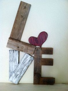 a wooden sculpture with a heart on top of it