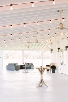 an open room with white walls and lights on the ceiling