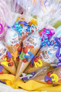 an ice cream cone filled with lots of colorful candies in plastic wrapper bags