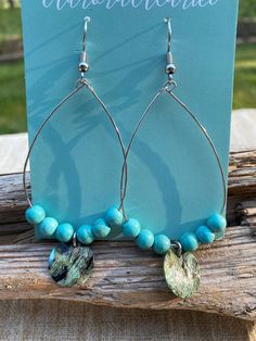 Dive into the ocean's essence with these Turquoise & Shell Hoop Earrings! These statement earrings combine the vibrant, skyward hue of turquoise with the luminous, pearlescent glow of shell, evoking the endless horizon and the treasures hidden beneath the waves. The perfect blend of bohemian charm and coastal chic, these hoops will transport you to a world of sun-kissed beaches and endless summers. Item ready to ship in a gift box for the special someone or you! Turquoise Teardrop Nickel-free Hoop Earrings, Nickel-free Turquoise Teardrop Hoop Earrings, Nickel-free Teardrop Turquoise Hoop Earrings, Teardrop Turquoise Nickel-free Hoop Earrings, Turquoise Teardrop Hoop Earrings Nickel Free, Adjustable Turquoise Teardrop Earrings, Teardrop Hoop Earrings With Ear Wire For Beach, Turquoise Nickel-free Small Hoop Earrings, Nickel-free Turquoise Small Hoop Earrings