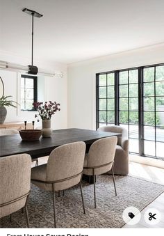 the dining room table is surrounded by beige chairs