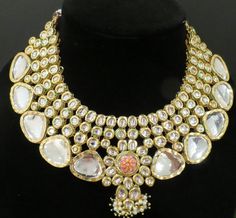 This beautiful choker is a modern twist to traditional jewelry and comes in a gold finish to match any outfit as desired. The choker is made of high quality stones and is a statement piece that can be dressed accordingly. The set comes with matching earrings and Tikka for a complete look. Gold Kundan Necklace With Cut Dana For Wedding, Gold Bridal Necklace With Cut Dana For Wedding, Festive Kundan Necklace With Cut Dana For Wedding, Indian Bridal Choker, Polki Necklace Set, Semi Precious Earrings, Pakistani Bridal Jewelry, Hand Painted Necklace, Beautiful Chokers