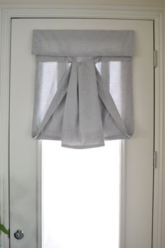 an open window with a curtain hanging from it's side