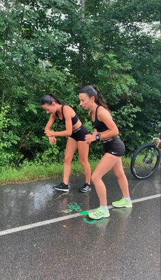 two young women are running in the rain