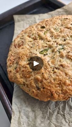 an uncooked piece of bread sitting on top of a pan covered in wax paper