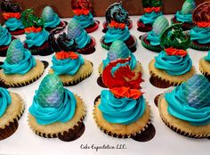 cupcakes with blue frosting and decorations on them