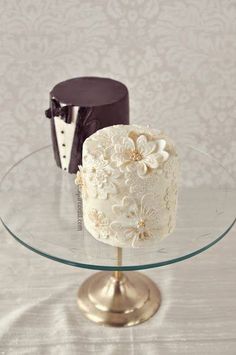 two cakes sitting on top of a glass cake plate with the words mini cakes above them