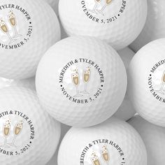 many white golf balls with champagne glasses on them and the names of their respective guests