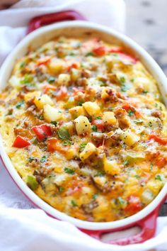 a casserole dish with meat, vegetables and cheese in it on a table