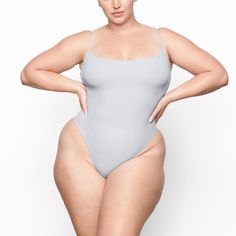 Fits Everybody Cami Bodysuit | Moonstone — With its wide scoop neckline and low back providing the perfect foundation under clothing, this Cami Bodysuit is an essential wardrobe foundation. Features a high cut leg opening and thong back that remains invisible under clothing. High Cut Leotard With Built-in Bra, High Cut Smoothing Bodysuit, One-piece Second-skin Smoothing Bodysuit, Smoothing Second-skin One-piece Bodysuit, Solid Color Backless Bodysuit With Minimal Stretch, Solid Color Minimal Stretch Backless Bodysuit, Second-skin High-cut Leg Shapewear Bodysuit, Solid Seamless Low Back Shapewear, High-cut Leg Lined Bodysuit