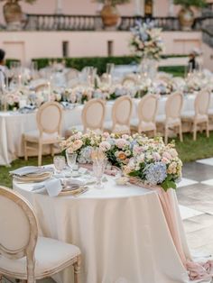 an outdoor wedding reception with tables and chairs