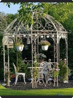 an outdoor gazebo with potted plants and chairs