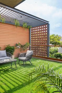 an outdoor living area with grass and plants