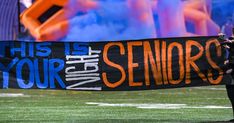 a man holding up a banner that says, this is your night senior's