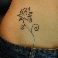 a woman's stomach with a flower tattoo on it