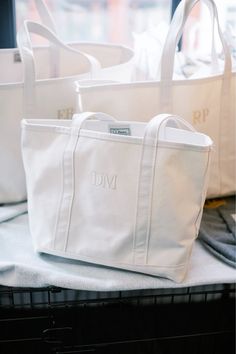 three white totes sitting on top of a table next to each other in front of a window