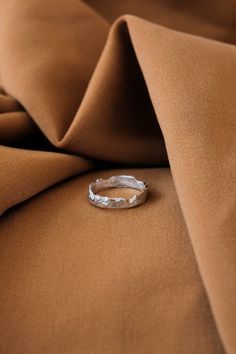 a ring is sitting on top of a brown fabric