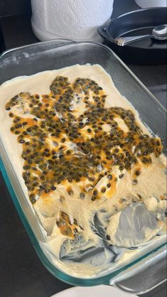 a casserole dish with cheese and black olives in it, ready to go into the oven