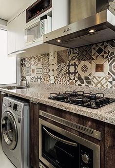 a stove top oven sitting inside of a kitchen next to a microwave and dishwasher