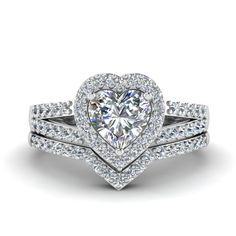 a heart shaped diamond engagement ring set on top of each other with two matching bands