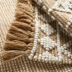 a close up view of an area rug with white and brown colors