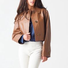 Elevate Your Cool-Girl Aesthetics With The Impeccably Tailored Vince Women's Cropped Leather Jacket. -Button Cuff Details, 2 Front Pockets -Mid Weight -Back Vents -Collared, Button Front Closure -100% Lamb Leather Chic Leather Jacket With Buttons For Winter, Chic Leather Blazer With Snap Buttons, Single Breasted Biker Jacket For Work And Fall, Luxury Biker Jacket For Fall Workwear, Fitted Leather Cropped Jacket For Work, Single-breasted Biker Jacket For Spring Workwear, Chic Winter Biker Jacket With Button Closure, Chic Single-breasted Leather Jacket For Winter, Winter Leather Cropped Jacket For Workwear