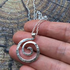 "SIZE: 1\" x 3/4\" (Available in 16\" or 18\" length) This tiny spiral pendant is inspired by the graceful spirals of the nautilus. Each spiral is hand shaped, hammered with my signature textured from my antique anvil. The texture comes from years of history, transferring every nick, dent and cranny which is transferred to the metal with every hammer stroke Great for every day, this tiny spiral pendant hangs from a delicate sterling chain with spring clasp and daisy loop giving it that extra lit Sacred Spiral, Spiral Jewelry, Celtic Spiral, The Nautilus, Ring Holder Necklace, Spiral Pendant, Spiral Necklace, Spiral Ring, Funky Jewelry