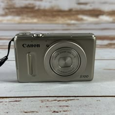 a digital camera sitting on top of a wooden table