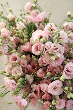 a bouquet of pink flowers sitting on top of a table