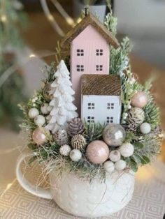 a white cup filled with ornaments and a house