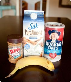 a banana, yogurt, peanut butter and other items on a table