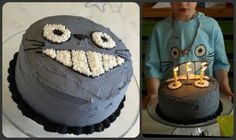 there is a birthday cake with candles in the shape of a cat and an angry face