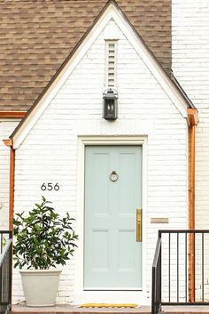 a white house with a blue front door