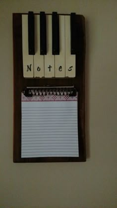 a notepad attached to a wall with a piano keyboard