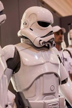 a group of people in star wars uniforms standing next to each other with helmets on