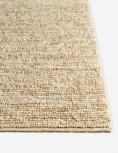 an area rug made out of jute and wool with a white border on the floor